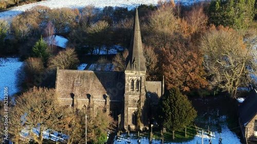 Aerial footage of the Christ Church Douglas-in-Parbold on a sunny day winter day in Parbold, England photo