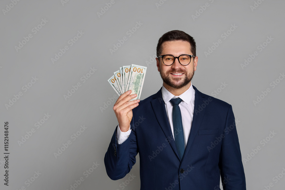 Portrait of banker with dollar banknotes on grey background, space for text Portrait of banker with dollar banknotes on grey background, space for text