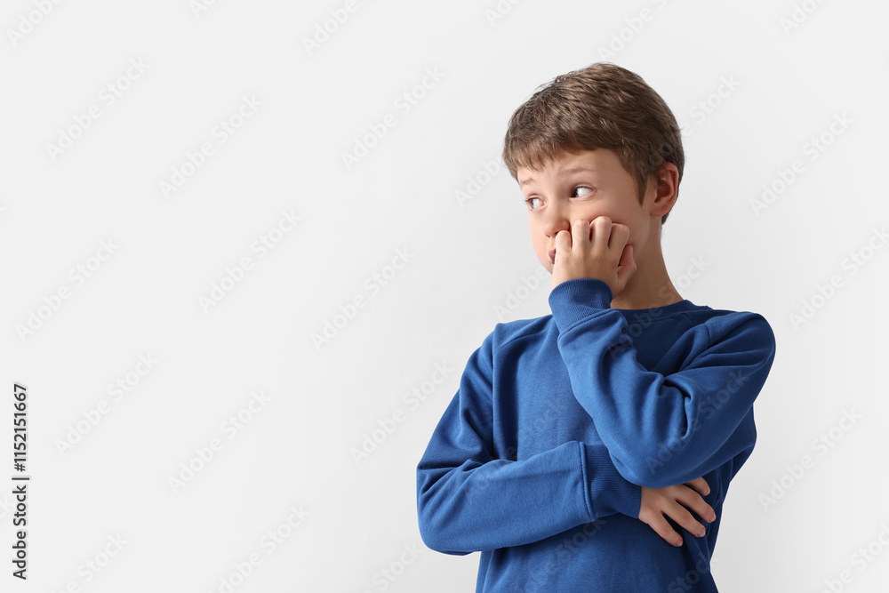Scared little boy on light background. Space for text Scared little boy on light background. Space for text