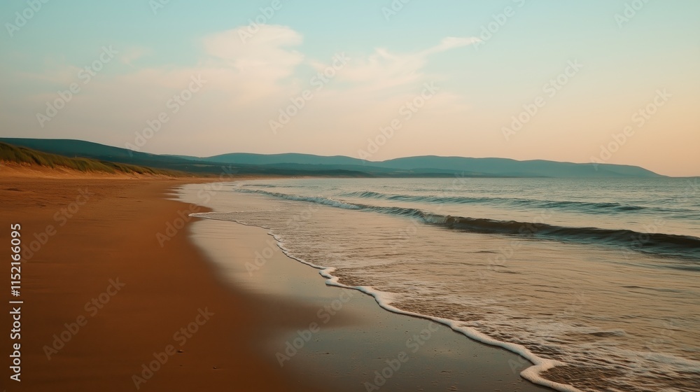 Obraz premium Serene Pastel Beach at Sunrise with Gentle Waves and Hills in the Background, Perfect for Relaxation and Calmness, Ideal for Travel and Nature Themes