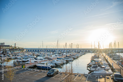 sunrise in a port full of sailboats in tarragona on the coast of the mediterranean sea in spain europe photo