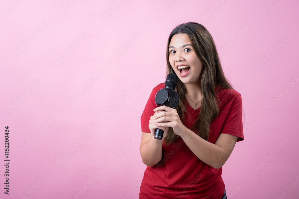 A cheerful asian woman with long brown hair and light skin, wearing a red T-shirt, sings into a black microphone with an enthusiastic expression, standing against a vibrant pink background. A cheerful asian woman with long brown hair and light skin, wearing a red T-shirt, sings into a black microphone with an enthusiastic expression, standing against a vibrant pink background.