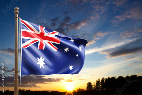 Flag of Australia waving in the wind on the flagpole against the sunset. National Holidays concept