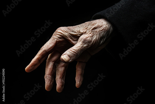 Old hands of the person on a black background