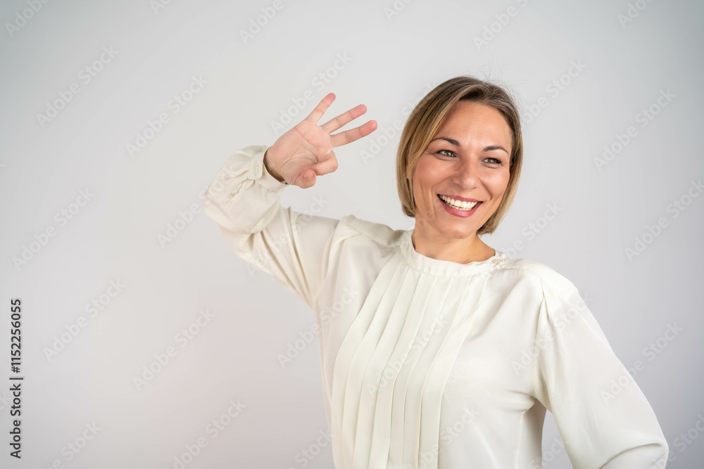 Portrait of a happy mature blonde woman showing ok gesture. Beautiful woman smiling and showing OK sign. Presenting your product. Expressive facial expressions. Portrait of a happy mature blonde woman showing ok gesture. Beautiful woman smiling and showing OK sign. Presenting your product. Expressive facial expressions.