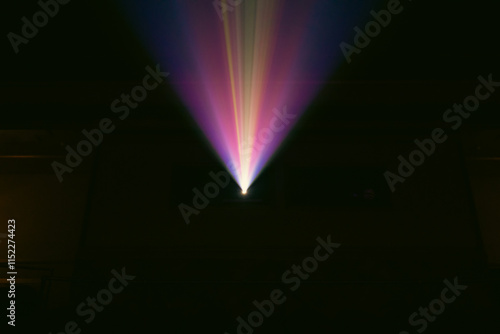 view of a colorful light beam in a dark room 