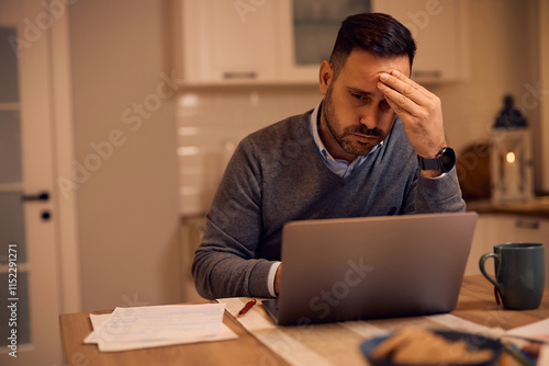 Fotografía Worried businessman reading problematic email on laptop at home.