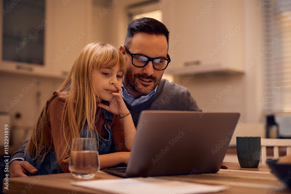 Little girl and her father using computer at home. Little girl and her father using computer at home.