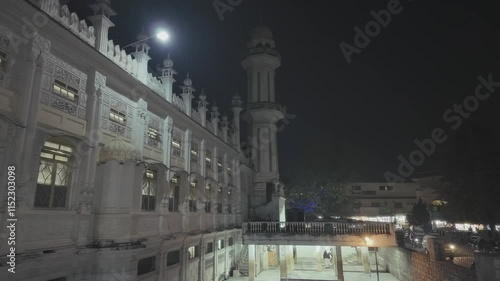 Drone view of Ilyasi Masjid with street view at night in Abbottabad, Pakistan photo