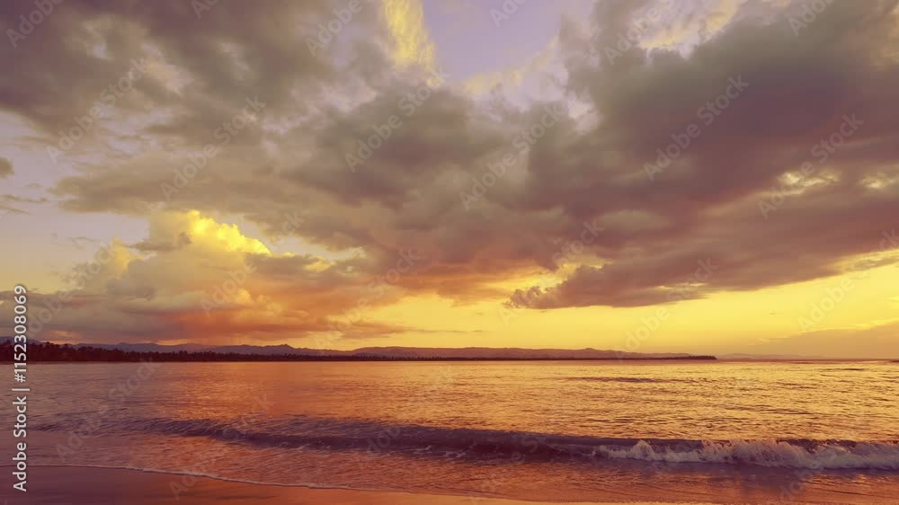 Sea waves crashing on sandy beach against sunset sky with clouds. Vibrant nature of sea coast. Summer evening on untouched clean tropical Hawaiian beach. Picturesque summer landscape. Sea waves crashing on sandy beach against sunset sky with clouds. Vibrant nature of sea coast. Summer evening on untouched clean tropical Hawaiian beach. Picturesque summer landscape.