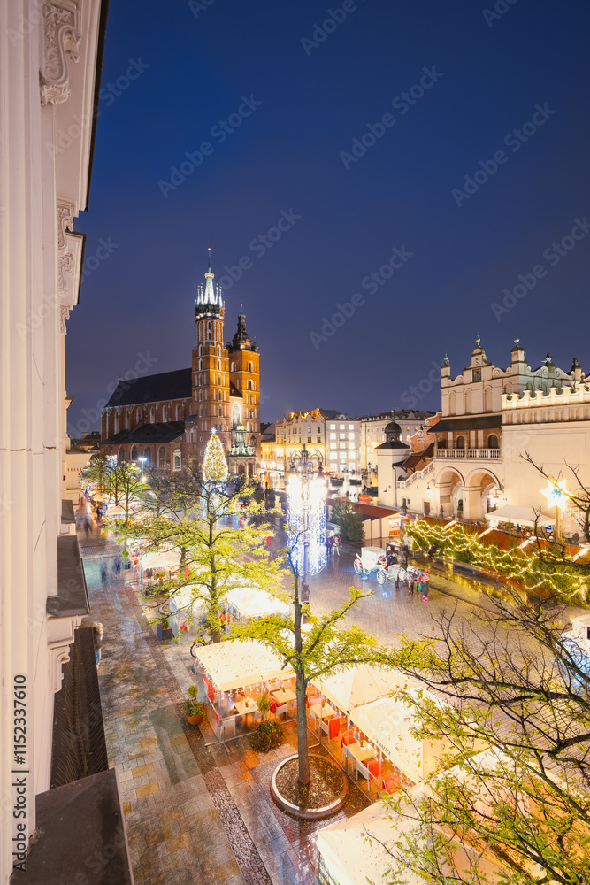 View of the Krakow Christmas Market 2024 and the historic Old Town Square, beautifully illuminated with festive lights and vibrant holiday atmosphere.