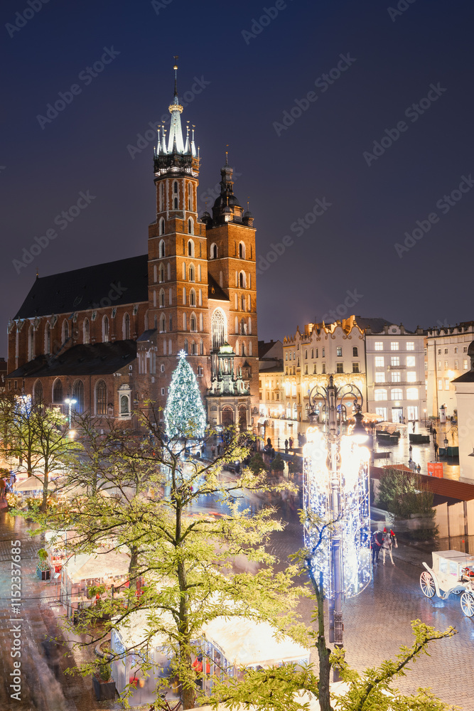 View of the Krakow Christmas Market 2024 and the historic Old Town Square, beautifully illuminated with festive lights and vibrant holiday atmosphere.