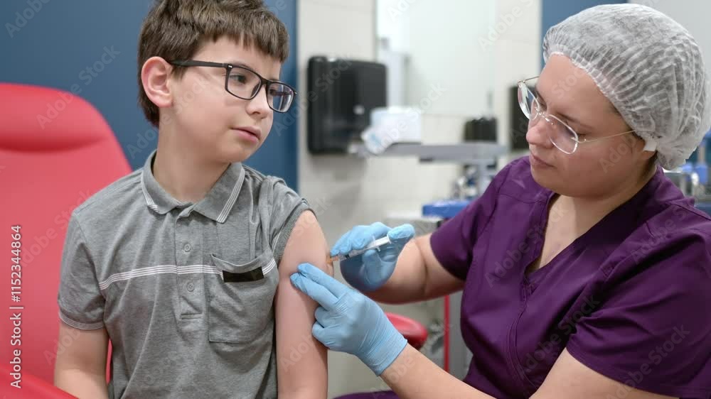 A boy is being vaccinated. A child is given a vaccine during an epidemic or outbreak of a disease. A kid during routine vaccination A boy is being vaccinated. A child is given a vaccine during an epidemic or outbreak of a disease. A kid during routine vaccination