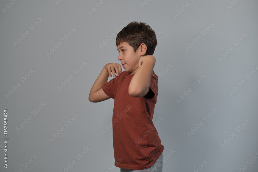 A young boy strikes a playful pose, showing energy and creativity. His lively expression adds to the cheerful atmosphere. A young boy strikes a playful pose, showing energy and creativity. His lively expression adds to the cheerful atmosphere.