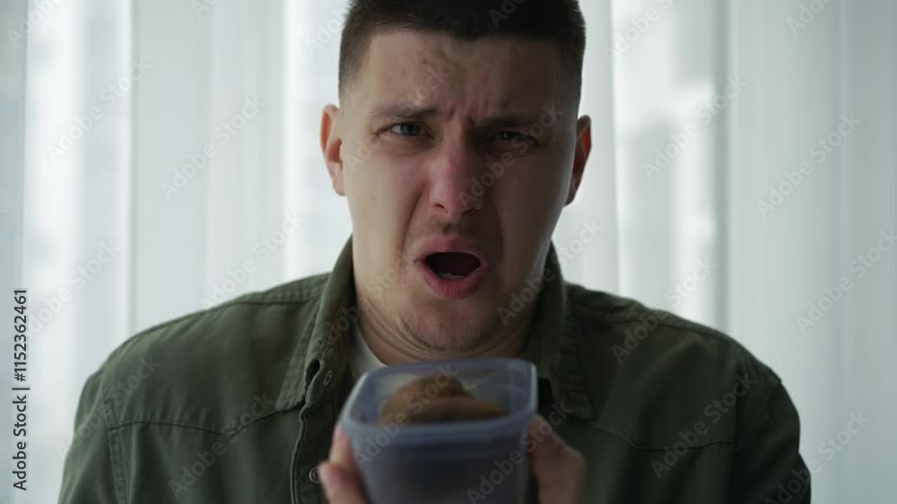 A man sniffs something in a plastic box.
Unpleasant odor from a plastic container.
Rotten food in a box.
Unpleasant smell.
Gesture of what stinks A man sniffs something in a plastic box.
Unpleasant odor from a plastic container.
Rotten food in a box.
Unpleasant smell.
Gesture of what stinks
