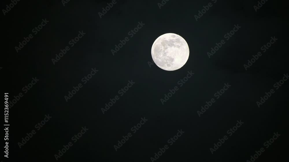 Full moon in the night sky with slightly cloud movement. Full moon in the night sky with slightly cloud movement.