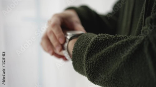 An accessory on a man's hand.
Mechanical wristwatch close-up.
A man checks the time on his watch photo