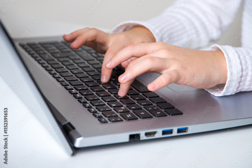 Children's fingers typing on the laptop keyboard. Learning concept. Children's fingers typing on the laptop keyboard. Learning concept.
