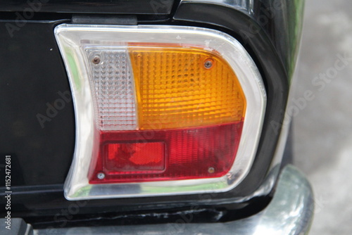 Close-up of a classic car's rear light with elegant design details, showcasing vintage automotive style and timeless craftsmanship, perfect for retro and automotive-themed content