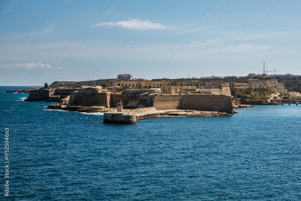 Ricasoli Lighthouse and Fort Ricasoli in Kalkara, Malta, overlooking the Mediterranean Sea, showcasing historic coastal defense architecture. Ricasoli Lighthouse and Fort Ricasoli in Kalkara, Malta, overlooking the Mediterranean Sea, showcasing historic coastal defense architecture.