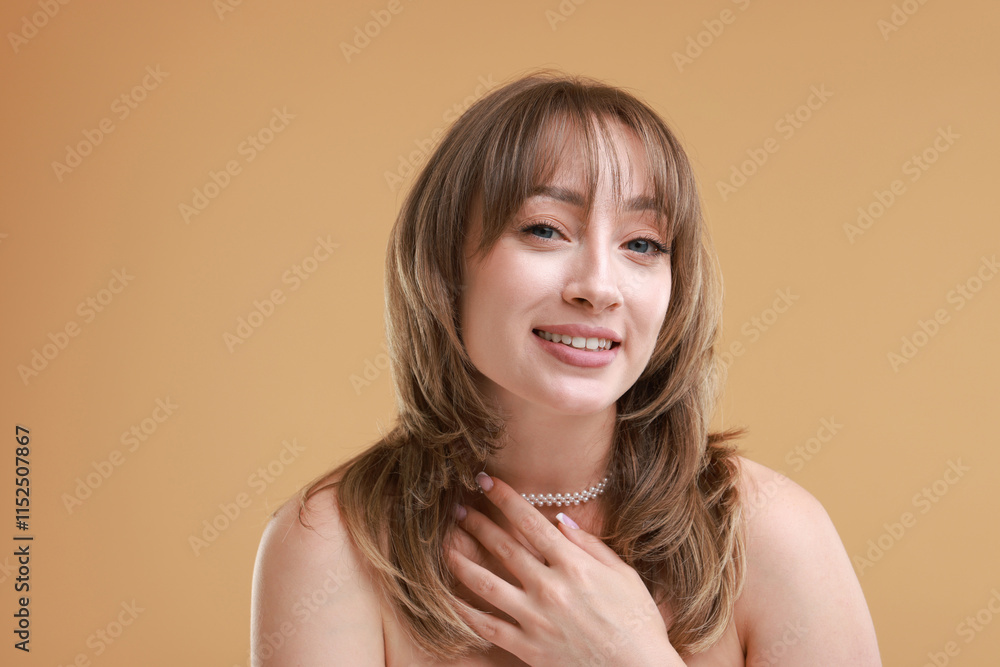 Fototapeta premium Attractive woman with stylish haircut on beige background