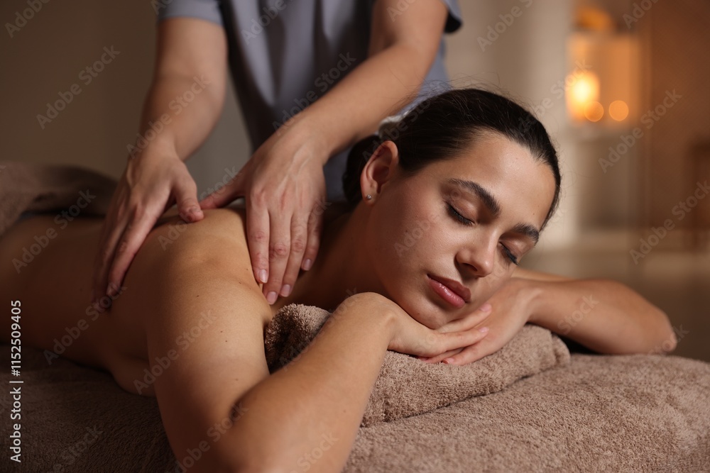 Woman receiving back massage in spa salon Woman receiving back massage in spa salon