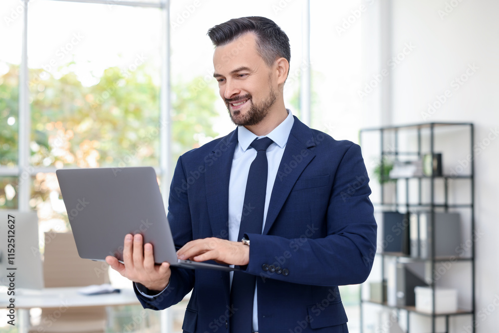 Smiling banker working with laptop in office Smiling banker working with laptop in office