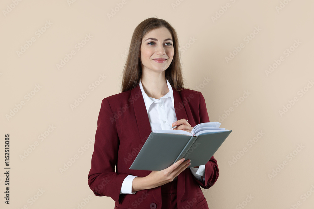 Portrait of smiling banker with book on beige background Portrait of smiling banker with book on beige background