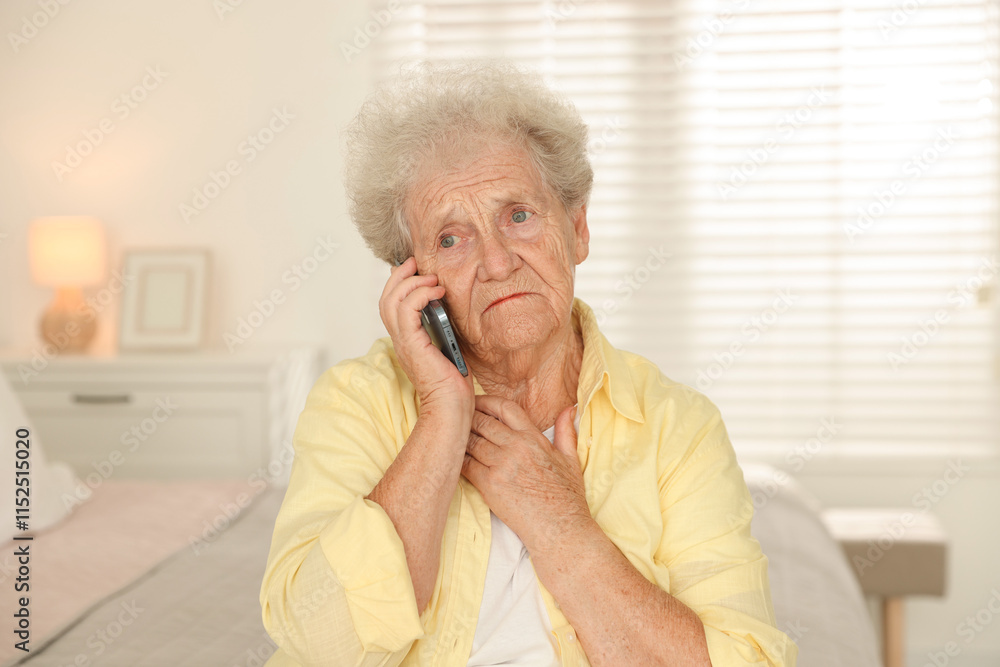 Senior woman talking on smartphone at home Senior woman talking on smartphone at home