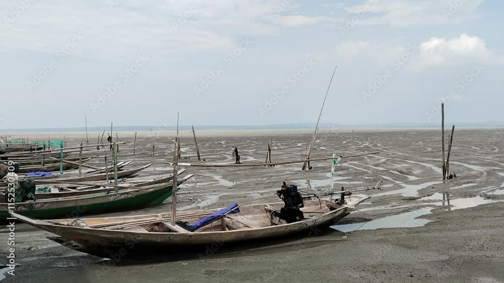 One afternoon, when the seawater was low, fishing boats were moored at Kenjeran Beach, Surabaya. Fishermen usually start going to sea in the afternoon at around 4 pm and return around 3 am. One afternoon, when the seawater was low, fishing boats were moored at Kenjeran Beach, Surabaya. Fishermen usually start going to sea in the afternoon at around 4 pm and return around 3 am.