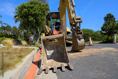 Fotografija Excavator parked in a residential street, road works, construction in Rancho Palos Verdes, California