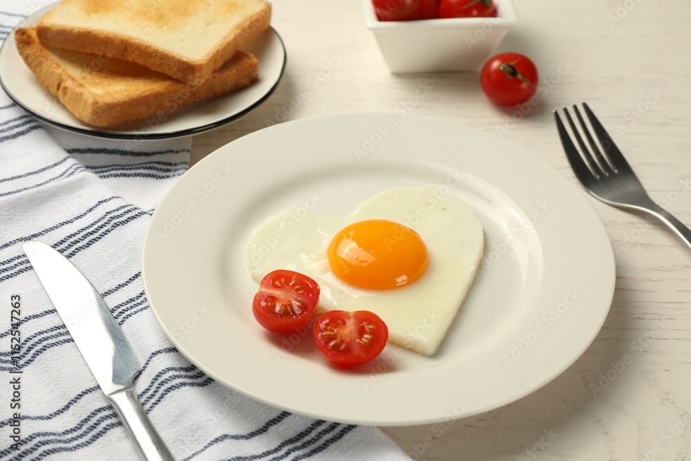 Heart shaped fried egg served on white wooden table Heart shaped fried egg served on white wooden table