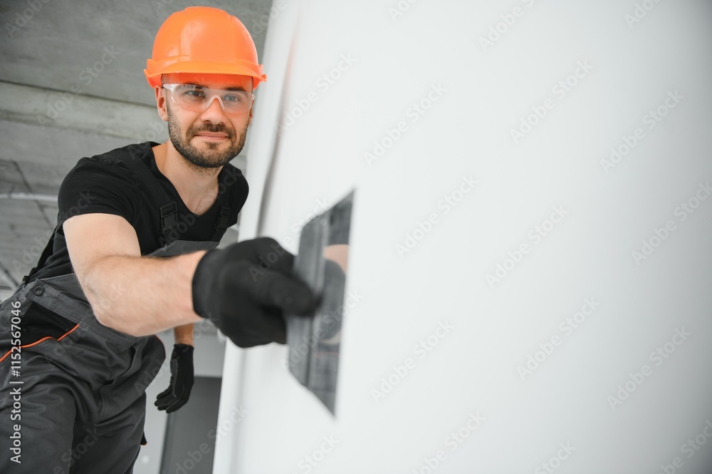 man drywall worker or plasterer putting mesh tape for plasterboard on a wall using a spatula and plaster. man drywall worker or plasterer putting mesh tape for plasterboard on a wall using a spatula and plaster.