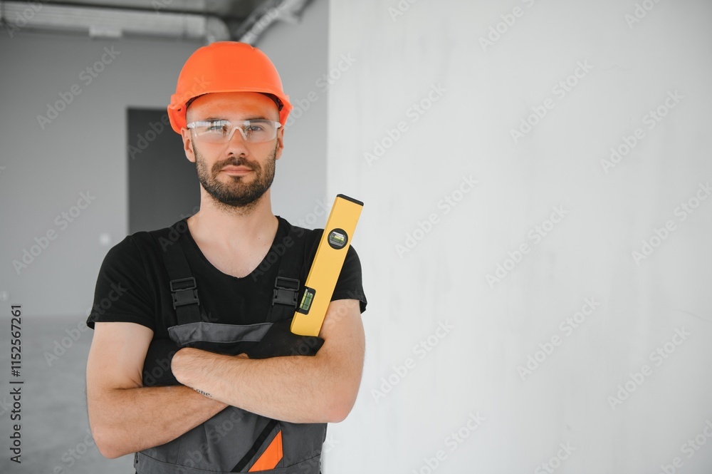 Construction Worker in uniform with spirit level Construction Worker in uniform with spirit level