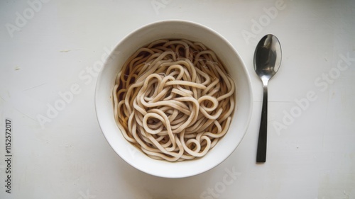 Simple presentation of udon noodles on a white tabletop photo