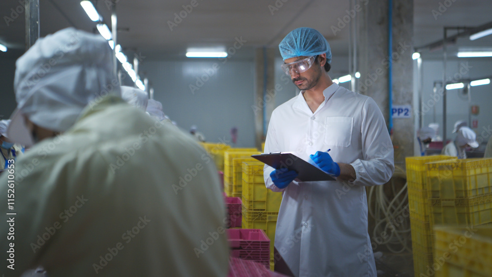 Production control supervisor inspects and controls the operation of each step in the production line of a canned fish factory Production control supervisor inspects and controls the operation of each step in the production line of a canned fish factory