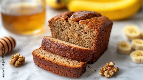 Delicious honey-glazed banana bread, sliced and ready to serve. Perfect for a sweet treat or breakfast, this photo highlights homemade baking.