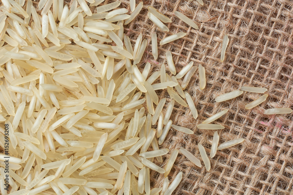 close-up macro view of raw basmati rice grains on natural rustic fabric, creamy white color grainy food taken straight from above with copy space close-up macro view of raw basmati rice grains on natural rustic fabric, creamy white color grainy food taken straight from above with copy space