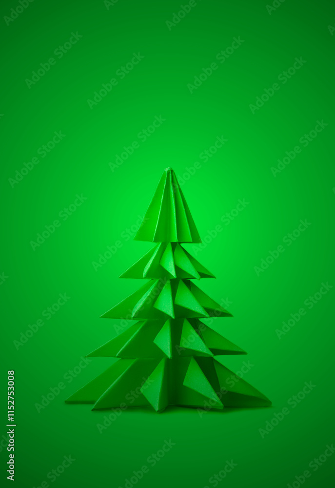 Obraz premium close-up of origami pine tree on bright green background, elegant card, minimalist paper crafted seasonal decoration with copy space