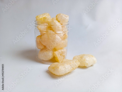 Kerupuk kulit sapi or rambak or beef skin crackers in a plastic jar, crackers with a savory and crispy taste photo