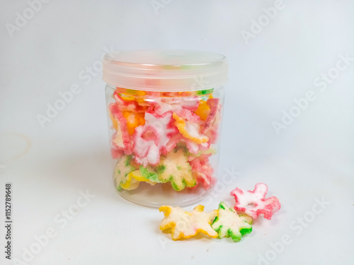 Kerupuk bunga or kerupuk mawar or flower cracker or rose cracker serve on plastic jar. Are typically deep-fried until crispy and are often served as a snack or a side dish in Indonesia. photo