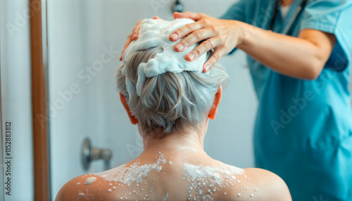 A nurse helps an elderly woman wash her hair with foam