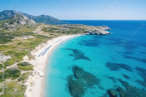 Aerial view of a secluded beach with turquoise water and white sand.