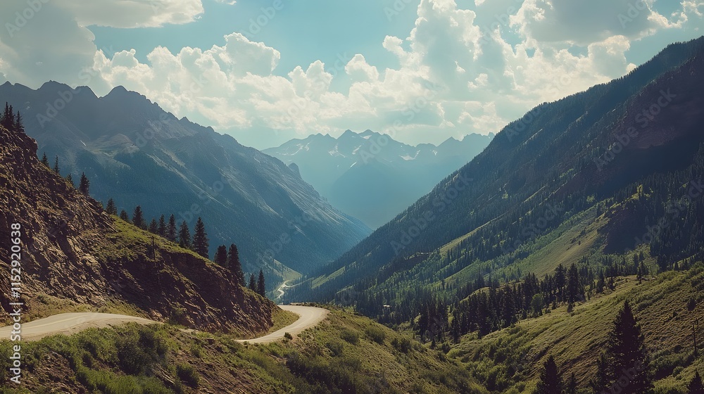 Obraz premium Mountain Road Winding Through Majestic Peaks