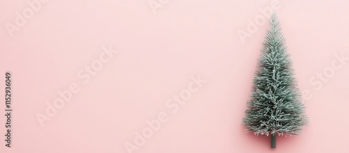 Minimalist Christmas tree design featuring a frosted tree on a soft pink pastel background for a serene holiday aesthetic.