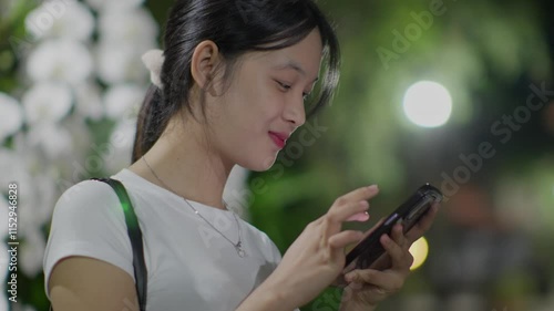 Woman using smartphone at night, Night lights, Bokeh of lights.