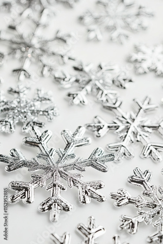 Silver snowflakes scattered across a white surface, representing winter elegance during Christmas time photo