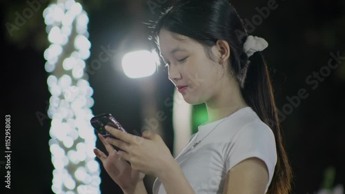 Woman using smartphone at night, Night lights, Bokeh of lights.