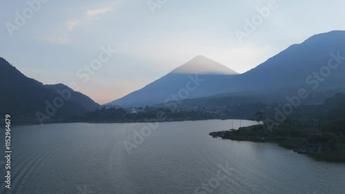 Pinturesque view of Lago Atitlan surrounded by volcanoes and hills at sunset, highlighting Guatemala's stunning natural landscape photo