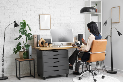Young woman working with co...